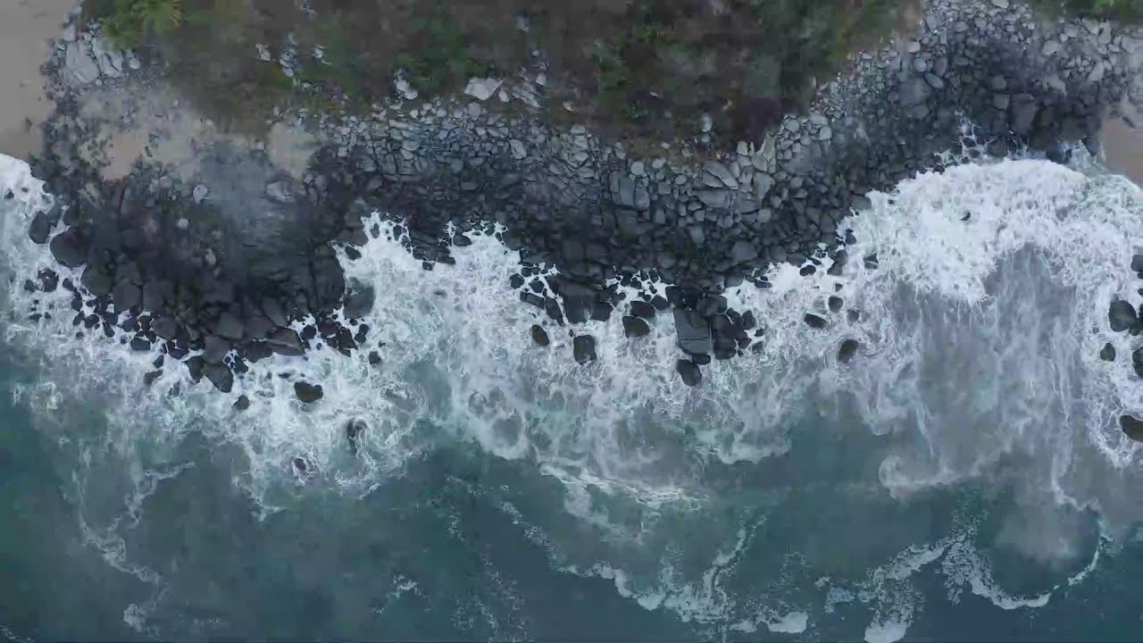 Drone Footage || View of People Surfing || Top aerial shot of seashore with rocks